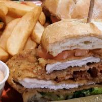 Hoosier Pork Tenderloin Sandwich · Pork loin is pounded thin, battered and deep fried golden. Presented on a roll with spicy mi...