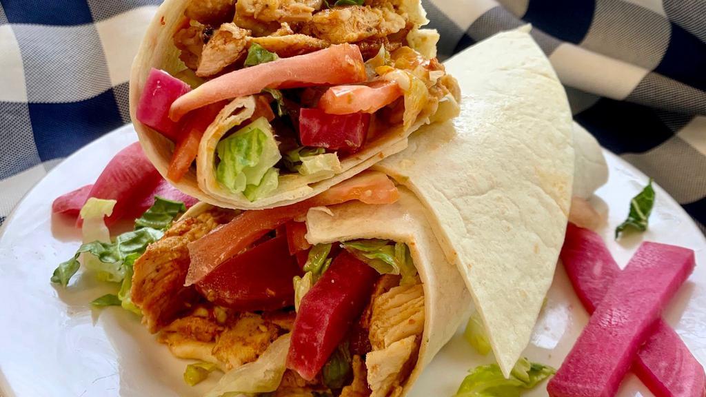 Chicken Shawarma Wrap · One of our best-sellers! Chicken shawarma wrapped with hummus, lettuce, tomatoes, pickles & homemade garlic sauce. Add Shatta (our homemade Middle Eastern hot sauce) if you like it spicy!