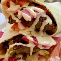 Falafel Wrap · Falafel wrapped with hummus, lettuce, tomatoes, pickles & homemade tahini sauce. Add Shatta ...