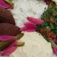 Kibbie Platter · Our homemade kibbie served with our classic homemade hummus, tabouleh, pickles and homemade ...
