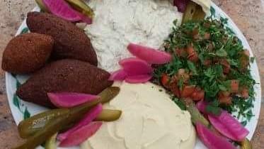 Kibbie Platter · Our homemade kibbie served with our classic homemade hummus, tabouleh, pickles and homemade parsley tahini sauce