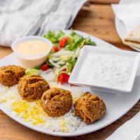 Falafel Over Rice & Salad · Crispy falafels with locally grown farmers market vegetables over a bed of rice.