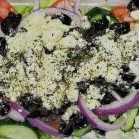 Greek Salad · Freshly made salad with lettuce, tomatoes, cucumbers, lemons, red onions, topped with black ...