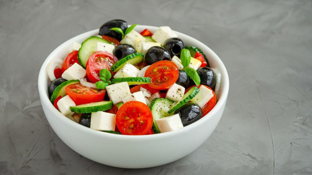 Greek Salad · Mixed greens, tomatoes, cucumbers, feta, olives, peppers, and anchovies, with a dressing.