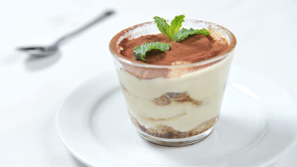 Tiramisu Cup · Slightly sweet and tangy mascarpone whipped cream is layered with spiked-coffee-dipped lady fingers and then dusted with cocoa powder.