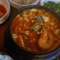 Seafood Soft Tofu Soup · seafood - clam , shrimp . half shell mussel and rice ,4 kind of side dish ( seasonal  )