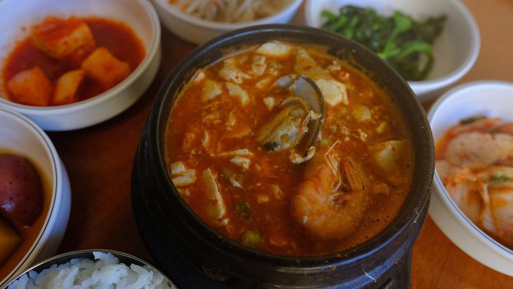 Seafood Soft Tofu Soup · seafood - clam , shrimp . half shell mussel and rice ,4 kind of side dish ( seasonal  )