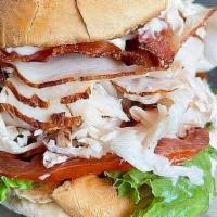 The Orange Pack · Club sandwich with choice of roast turkey or breaded chicken with mayo, lettuce, tomatoes, a...