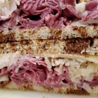 Ellis Island Reuben · Hot corned beef, melted Swiss cheese, and sauerkraut with homemade Russian dressing on toast...