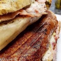 Cuban Panini · Slow roasted pulled pork, hot ham, melted Swiss cheese, dill pickles, spicy mustard and home...