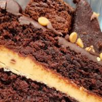 Mile High Peanut Butter Cake · Rich Chocolate Cake with layers of Peanut Butter, Topped with Chocolate Ganache and Fudge Br...