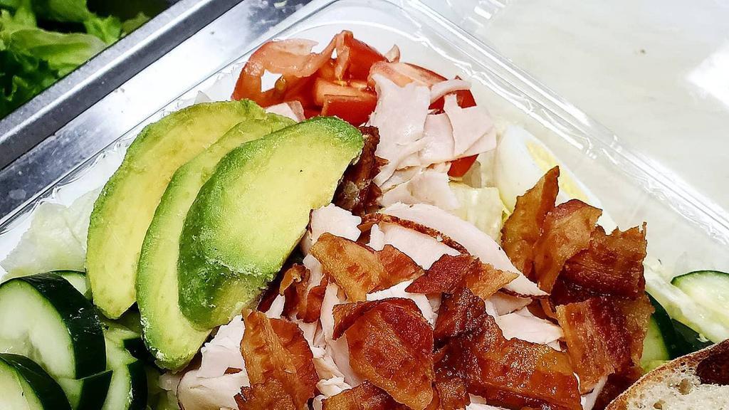 Cobb Salad · Mixed greens topped with roast turkey, bacon, avocado, hard boiled egg, cucumbers, and tomatoes.