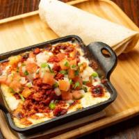 Queso Fundido · Melted cheese with Mexican sauce made of mushrooms or chorizo served with flour tortillas.