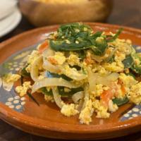 Huevos A La Mexicana · Scramble eggs with jalapeño pepper, tomatoes and onions served with rice and beans.