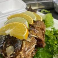 Mojarra Frita · Fried tilapia served with a green salad and rice.