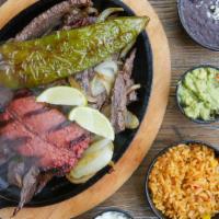 Carne Asada · Grilled sirloin served with grilled onions, jalapenos, salad, avocado, rice, beans, and tort...