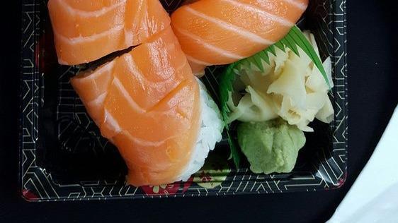 Orange · Crab, avocado, and cucumber wrapped with salmon.