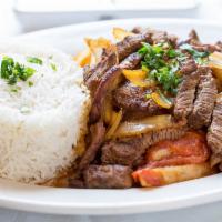 Lomo Saltado · Sliced beef chunks sautéed with red onions and tomatoes, served over french fries.