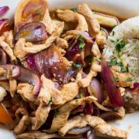 Pollo Saltado · Sliced Chicken chunks sautéed with red onions and tomatoes, served over french fries.