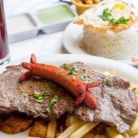 Bistec A Lo Pobre · Steak served with fries, sweet plantains, hot dog, rice, and fried egg.
