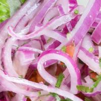 Salsa Criolla · Traditional red onion salad with chopped tomatoes and fresh cilantro marinated in lime juice.