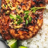 Jerked Chicken Dinner · Jerk chicken dinner with homemade sauce, served with either white rice or rice and beans.