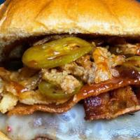 Backyard Burger · Six oz burger, BBQ sauce, bacon, fried onion, jalapeños, pepper Jack cheese.