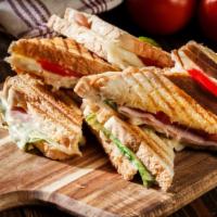 Italiano Panini · Delicious panini made with slices of ham, provolone cheese, sun-dried tomatoes, baby spinach...