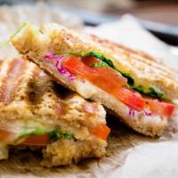 Time Square Panini · Delicious panini made with slices of turkey, juicy bacon, cracked pepper, Swiss cheese, cole...