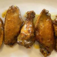 Alitas De Pollo · Crispy chicken wings in your choice of Spicy mango habanero or cilantro lime mojo.