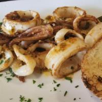 Calamares A La Parilla · Grilled calamari in smoked chimichurri, served with grilled Cuban bread.