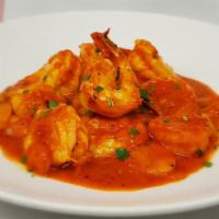 Camarones Enchilados · Fresh shrimp in roasted red pepper, tomato and white wine adobo sauce.