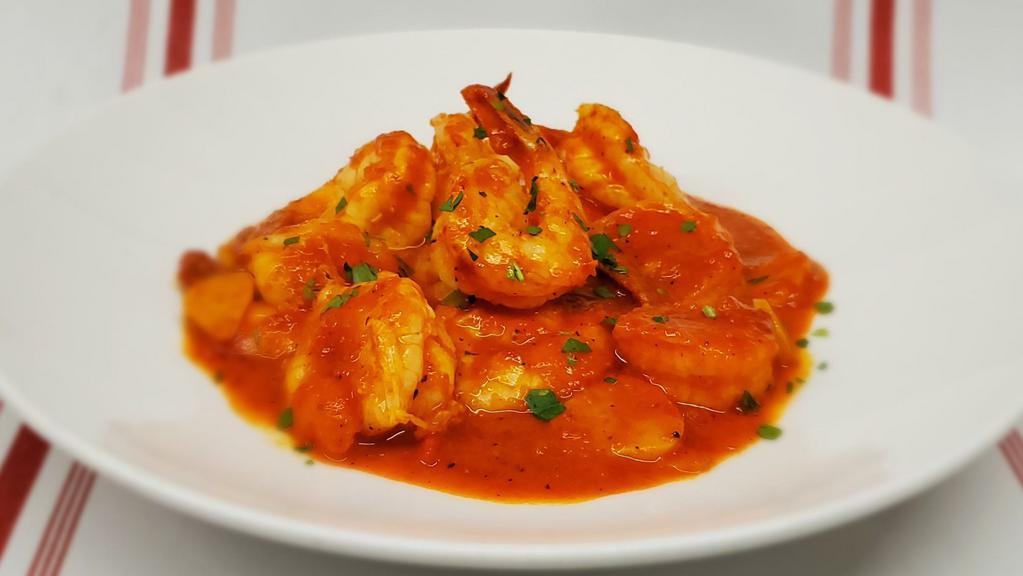 Camarones Enchilados · Fresh shrimp in roasted red pepper, tomato and white wine adobo sauce.