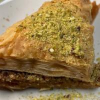 Baklava · Thin layers of pastry shells with honey and nuts topped with crushed pistachios.