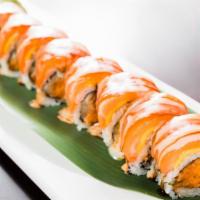 Sexy Pink Lady Roll · Spicy salmon and cucumber with crunch on inside, salmon, and mango on outside, topped with s...