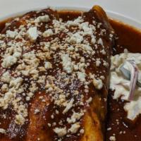 Two Enchiladas · Filled with chicken, Roast pork pibil, beef picadillo or cheese. Suizas, guajillo, house sal...