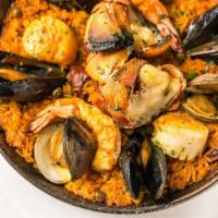 Paella · Clams, Mussels, Scallops,  shrimp, chorizo, market fish, rice with saffron sofrito.