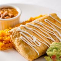 Burrito Or Chimichanga · Large flour tortilla baked or fried, stuffed with stewed chicken or beef picadillo, guacamol...