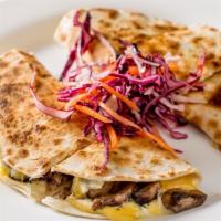Hongos Quesadilla · Mushrooms, jalapenos, roasted garlic. and our house blen of cheeses. Served with crema and s...