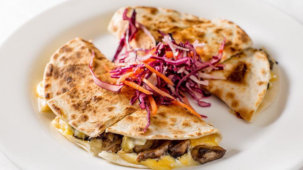 Hongos Quesadilla · Mushrooms, jalapenos, roasted garlic. and our house blen of cheeses. Served with crema and salsa.