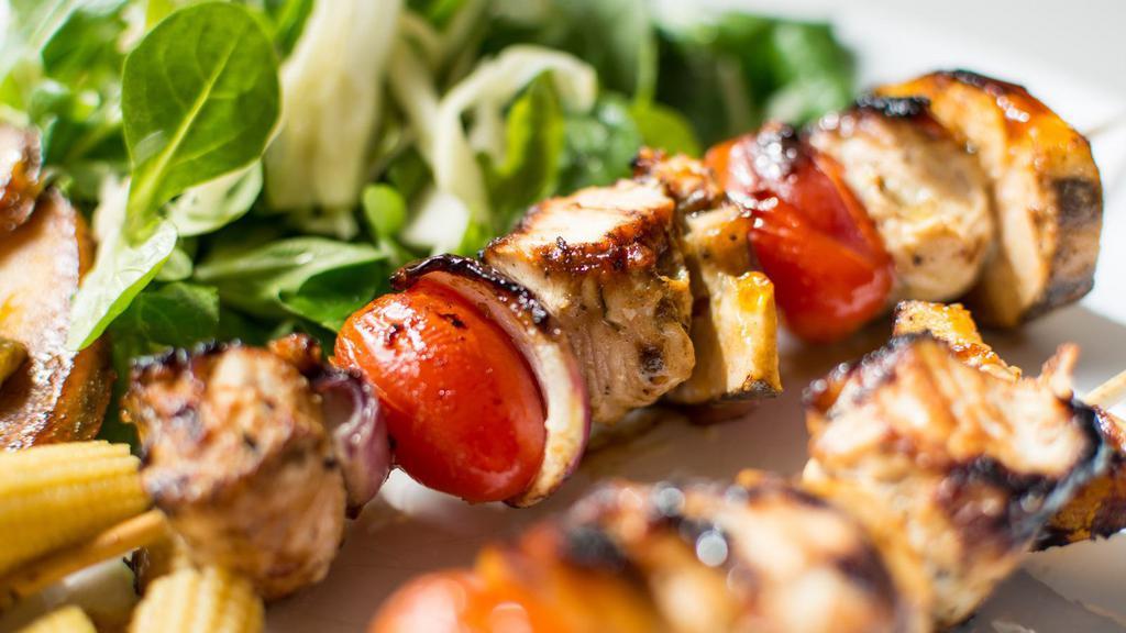 Chicken Shish Kebab · Char-grilled chunks of chicken breasts served with rice and vegetables. Served with rice, pita bread, vegetables, lettuce, onions, tomato and red cabbage.