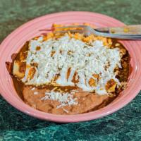 Enchiladas Suizas · Tortilla rolled around a filling and covered with a chili pepper sauce, choice of red or gre...