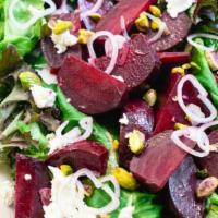 Beet Salad · Roasted red and golden beets, mesclun, onions, walnuts and goat cheese red wine vinaigrette.