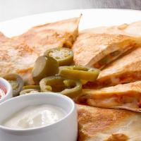Four Cheese Quesadilla With Jalapeños · Mouthwatering Quesadilla made with Pepper jack cheese, Swiss cheese, fresh Mozzarella cheese...