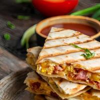Four Cheese Quesadilla With Bacon · Mouthwatering Quesadilla made with Pepper jack cheese, Swiss cheese, fresh Mozzarella cheese...
