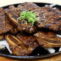 La Galbi Platter (갈비프레터) · Korean Rib with Special Galbi Sauce over Fried Onion. Rice, Spicy Soy radish and Kimchi. Per...