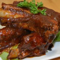 Bbq Ribs · Slow cooked tender pork ribs, glazed in house blend sauce.