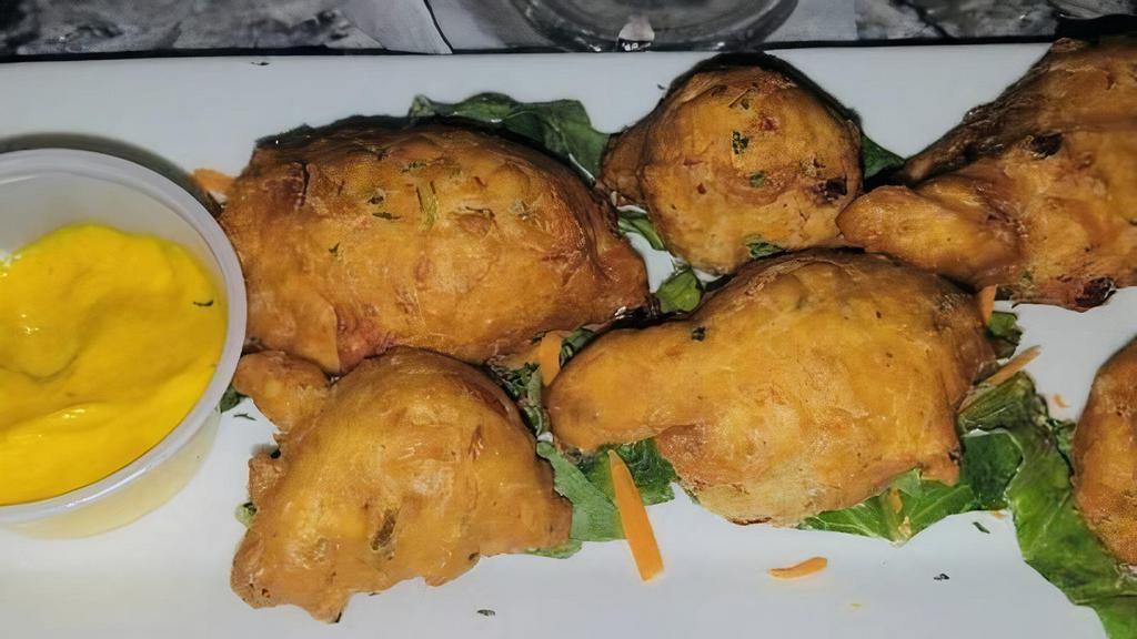 Codfish Fritters · Island style seasoned fritters with fritter sauce.