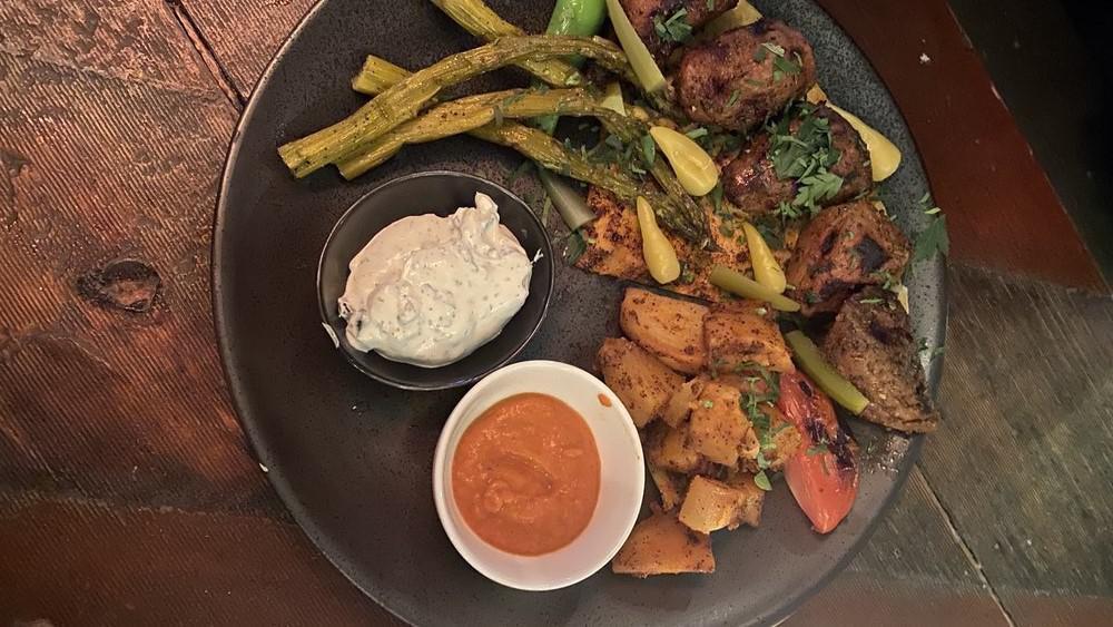 Lamb Brochettes · Fire-roasted tender cubes of marinated chicken thigh or lamb, served with roasted potatoes and asparagus.