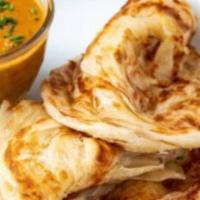 Roti Canai · Indian pancake with curry sauce. Hot and spicy.